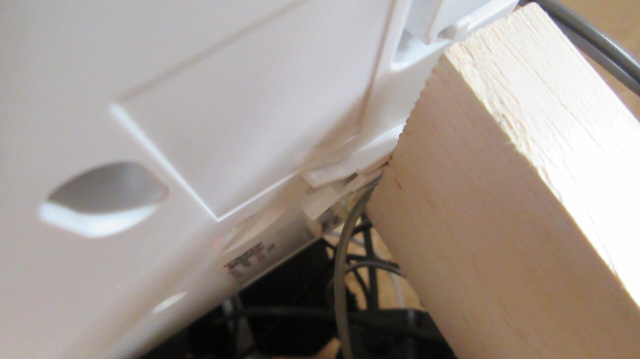 カーペット鋲の頭をフック用穴に滑り込ませたようす